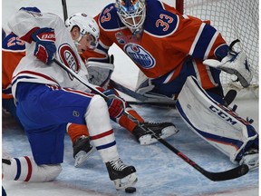 Edmonton Oilers goalie Cam Talbot eyes the puck as Montreal Canadiens Artturi Lehkonen loses his footing at Rogers Place in Edmonton on Sunday, March 12, 2017. (Ed Kaiser)