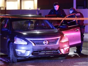 Edmonton Police Service officers investigate the scene of a shooting at 163 Street and 99 Avenue.