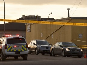 Edmonton Police Service officers investigate two vehicles parked near an EMS vehicle in the area of 52 Street and 128 Avenue in Edmonton on Thursday, March 30, 2017.