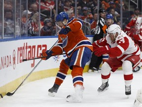 Edmonton's Adam Larsson (6) battles Detroit's Gustav Nyquist (14) during the first period of a NHL game between the Edmonton Oilers and the Detroit Red Wings at Rogers Place in Edmonton on Saturday, March 4, 2017.