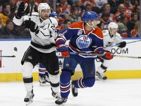 Los Angeles Kings forward Trevor Lewis, left, battles with Edmonton Oilers defenceman Andrej Sekera during NHL action March 20, 2017, at Edmonton's Rogers Place.