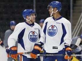 Edmonton Oilers players Drake Caggiula, left, and Darnell Nurse chat during practice at Rogers Place in Edmonton on Friday, March 17, 2017.