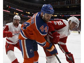 Edmonton Oilers forward Zack Kassian battles along the boards with Detroit Red Wings Anthony Mantha (39) and Frans Nielsen (51) at Rogers Place in Edmonton on Saturday, March 4, 2017. (Ian Kucerak)
