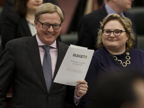 Education Minister David Eggen (left) and Sarah Hoffman, deputy premier and minister of health, hold a copy of the 2017 Alberta budget on March 16, 2017. Not everything on Education Minister David Eggen's wish list was in the 2017-18 budget but Edmonton did get funding for four new schools.