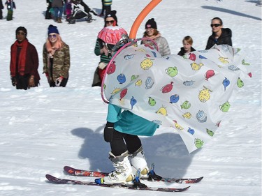 Elyse Pittard, 13, is about to take a shower while wearing a shower curtain during the annual Slush Cup festival at the Edmonton Ski Club on Saturday, March 18, 2017.