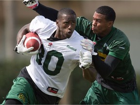 Eskimos wide receiver Bryant Mitchell attempts to elude a tackle from tryout hopeful Jarred Evans during the team's mini-camp at Historic Dodgertown in Vero Beach, Fla., on April 17, 2016. (File)