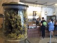 In this April 20, 2016, file photo, customers buy products at the Harvest Medical Marijuana Dispensary in San Francisco, Calif.