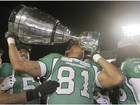 Saskatchewan Roughriders Geroy Simon kisses the Grey Cup after beating the Hamilton Tiger-Cats in the 101st CFL Grey Cup in Regina, Sask., on Sunday November 24, 2013.