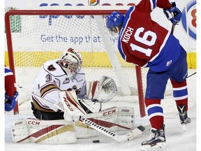 Calgary Hitmen goalie Cody Punter, left, tries to stop Edmonton Oil Kings Davis Koch, right, from scoring in WHL action at the Scotiabank Saddledome in Calgary, Alberta, on Sunday, March 12, 2017. The Oil Kings conclude their season this weekend with a home-and-home series against the Red Deer Rebels.