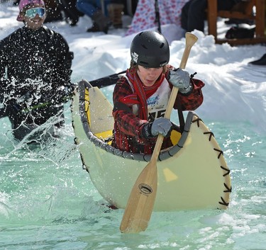 Nick Saunchers tries using a canoe during the annual Slush Cup festival at the Edmonton Ski Club on Saturday, March 18, 2017.
