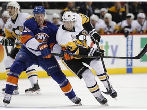 New York Islanders left-winger Jason Chimera defends against Pittsburgh Penguins center Eric Fehr on Nov. 30, 2016, in New York. (The Canadian Press)