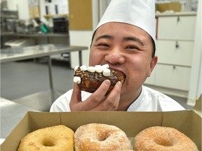 Jason Wang, head pastry chef at the Shaw Conference Centre, takes a bite of a treat from Doughnut Party.