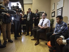 Alberta Finance Minister Joe Ceci speaks with media after presenting a new pair of soccer shoes to Yusef Moalim during a pre-budget photo opportunity in Edmonton, Alta., on Tuesday March 14, 2017. The new soccer shoes represent a more affordable lifestyle for families with the upcoming budget.