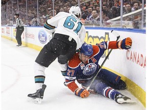 San Jose Sharks' Justin Braun (61) checks Edmonton Oilers' Milan Lucic (27) during second period NHL action in Edmonton, Alta., on Thursday, March 30, 2017.