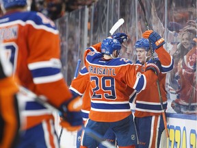 Edmonton Oilers linemates Leon Draisaitl (29) and Connor McDavid (97) celebrate McDavid's goal during the second period of NHL action against the Vancouver Canucks in Edmonton on March 18, 2017.