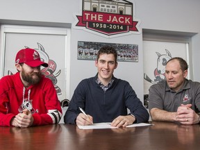 Niagara IceDogs defenceman Ryan Mantha is flanked by Joey Burke, left, and coach Dave Bell after signing a contract with the Edmonton Oilers of the National Hockey League on March 1, 2017.