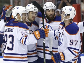 Edmonton Oilers defenseman Oscar Klefbom, second from left, celebrates with Matt Benning (83), Patrick Maroon (19) and Connor McDavid (97) after scoring a goal during the first period against the Florida Panthers during an NHL hockey game, Wednesday, Feb. 22, 2017, in Sunrise, Fla.