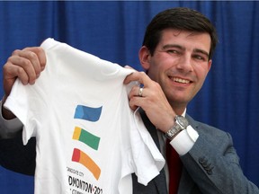 Mayor Don Iveson holds an Edmonton Commonwealth Games 2022 T-shirt during the announcement of the bid on the games in 2014.
