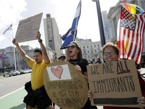 Demonstrators, including Michaela Danek, center, and Carmen Gonzalez, right, shout slogans during a protest against President Donald Trump's efforts to crack down on immigration Thursday, Feb. 16, 2017, in San Francisco. Immigrants around the country have been staying home from work and school today, hoping to demonstrate their importance to America's economy and its way of life.