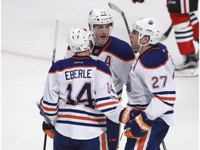 Edmonton Oilers left-winger Milan Lucic (27) celebrates his goal against the Chicago Blackhawks with teammates Jordan Eberle (14) and Ryan Nugent-Hopkins (93) Saturday, Feb. 18, 2017, in Chicago. (AP Photo)