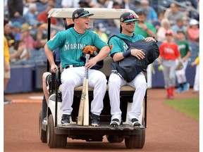 Kyle Seager, left, and Shawn O'Malley of the Seattle Mariners ride to the field on a golf cart prior to a spring training game against the Oakland Athletics at Peoria Stadium on March 5, 2017 in Peoria, AZ. (Jennifer Stewart/Getty Images)