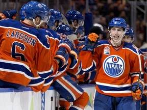 Edmonton Oilers centre Ryan Nugent-Hopkins, facing, celebrates a goal with his teammates against the Colorado Avalanche during third period NHL action at Edmonton's Rogers Place on March 25, 2017.