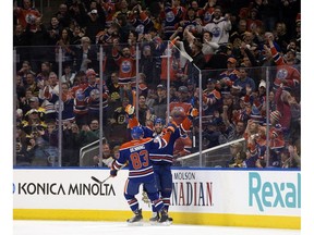 Edmonton Oilers teammates Matthew Benning (83) and Patrick Maroon (19) celebrate Maroon's goal against the Boston Bruins during first period NHL action, in Edmonton on March 16, 2017.