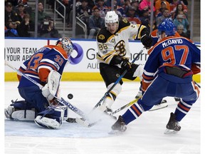 Edmonton Oilers goalie Cam Talbot and Connor McDavid stop the Boston Bruins' David Pastrnak in Edmonton on Thursday, March 16, 2017. (David Bloom)