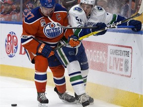 Edmonton Oilers captain Connor McDavid (97) battles the Vancouver Canucks defenceman Troy Stecher (51) during first period NHL action at Rogers Place, in Edmonton Saturday, March 18, 2017.