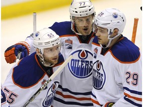 Edmonton Oilers' Oscar Klefbom (77) and Leon Draisaitl (29) congratulate Mark Letestu (55) after his goal against the St. Louis Blues on Feb. 28, 2017, in St. Louis. (AP Photo)