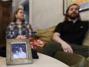 Maria Chaves-Turbide and her son Tom Ferreira (right) talk about the death of husband and father Frederick Turbide, pictured in photos with Maria on the table of the couple's Edmonton home. He died by suicide after suffering massive binary options trading losses.