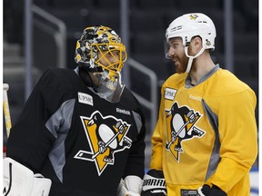 Pittsburgh Penguins goaltender Marc-Andre Fleury chats with defenceman Ian Cole during a practice at Rogers Place in Edmonton ahead of Friday's game against the Oilers. (Ian Kucerak)