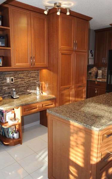After: They completely changed the look of the kitchen with new doors and matching "skin" to cover old cupboard frames.