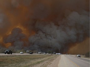 Fort McMurray residents flee southbound on Highway 63 on May 3, 2016, as a wildfire forced the evacuation of the northern Alberta city.