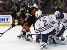Anaheim Ducks' Ryan Getzlaf, left, and Ryan Kesler (17) vie for the puck with Edmonton Oilers defenseman Andrej Sekera (2), of Slovakia; goalie Laurent Brossoit; and defenseman Kris Russell (4) defending during the second period of an NHL hockey game in Anaheim, Calif., Wednesday, March 22, 2017.
