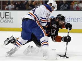 Anaheim Ducks center Ryan Kesler (17) takes a shot from his knees under pressure from Edmonton Oilers left wing Patrick Maroon (19) during the second period of an NHL hockey game in Anaheim, Calif., Wednesday, March 22, 2017.