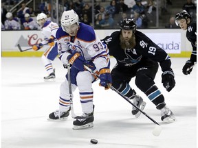 Edmonton Oilers' Ryan Nugent-Hopkins (93) vies for the puck against San Jose Sharks' Joe Thornton (19) during the first period of an NHL hockey game Thursday, Jan. 26, 2017, in San Jose, Calif. The Oilers  host the Sharks on Thursday.