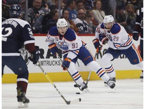 Edmonton Oilers center Ryan Nugent-Hopkins, center, leads centre Leon Draisaitl, of Germany, right, down the ice with the puck as Colorado Avalanche defenseman Francois Beauchemin drops back to cover pursues in the second period of an NHL hockey game Thursday, March 23, 2017, in Denver.