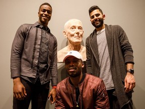 Sahr Saffa, left, Yembeh Moiba and Uzair Ahmed pose with a piece of art at the Art Gallery of Alberta's Refinery in Edmonton on Saturday, March 25, 2017.