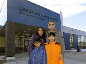 Sushma, left, and Daxesh Dalal, right, and their sons Krishan, 9, and Jayden, 11, outside Roberta MacAdams School in southwest Edmonton where the boys attend school. The family is concerned that there is no proposed new high school for southwest Edmonton, a rapidly growing area of the city.