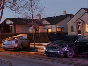 Two damaged cars are seen as Edmonton police officers investigate a crash in the area of 87 Street and 121 Avenue in Edmonton on Wednesday, March 22, 2017.
