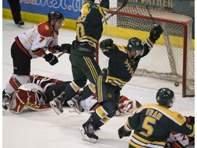 University of Alberta Golden Bears celebrate the game winning goal scored by Stephane Legault (not pictured) against the University of Calgary Dinos during Canada West semifinal game 2 action on Saturday February 25, 2017 at Clare Drake Arena in Edmonton.