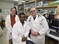 University of Alberta researchers Thomas Simmen, left, and Fabrizio Giuliani, right, along with post-doctoral fellow Yohannes Haile, in a laboratory on March 24, 2017, recently discovered an entirely new cellular mechanism — an underlying defect in brain cells — that may be to blame for multiple sclerosis. The finding opens the door to a brand new avenue of study in the battle against the cryptic autoimmune disorder.