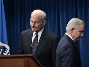 US Attorney General Jeff Sessions (R) makes his way from the podium as Homeland Security Secretary John Kelly arrives to speak on visa travel at the US Customs and Border Protection Press Room in the Reagan Building on March 6, 2017 in Washington, DC. US President Donald Trump signed a revised ban on travelers from six Muslim-majority nations Monday -- one with a reduced scope so Iraqis and permanent US residents are exempt.