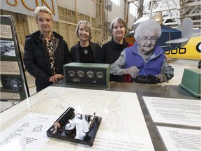 Daughters Geneve Fausak, left, Valerie Boyer and MaryBelle Thompson pose with a life-size cutout photograph of their mother, aviation legend Hazel Fausak, right, at an interactive display during the Women of Aviation Worldwide Week celebration held at the Alberta Aviation Museum in Edmonton on Saturday, March 11, 2017.