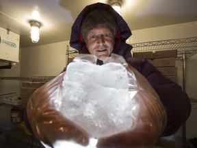 Professor Martin Sharp holds an ice core sample in the University of Alberta's glacier chemistry facility freezer, in Edmonton on Wednesday, Feb. 24, 2016.