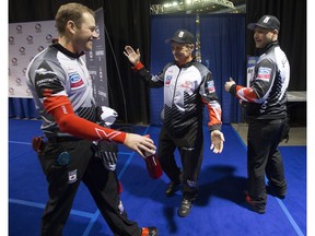 Team Canada's Geoff Walker, left, coach Jules Owchar, centre and Tom Sallows, joke around in the media area following their World Men's Curling Edmonton 2017 game against Team Italy at Northlands Coliseum, Thursday April 6, 2017.