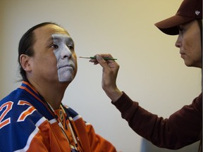 Edmonton Oilers superfan Blair Gladue has his face painted Oilers' colors by his sister Cora Gladue, in Edmonton Thursday April 27, 2017. Photo by David Bloom For Juris Graney story