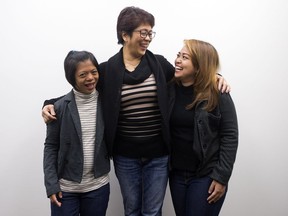 Mely Fernandez poses with her daughters Mia Denise Garcia Fernandez (left) and Zeina Fernandez (right) in her immigration lawyer's office, in downtown Edmonton Thursday April 27, 2017.