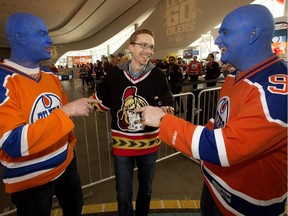 Edmonton Oilers fans Dean Ostafichuk and Jimmy Pietrarca talk to Senators fan Stuart Thomson in Ford Hall at Rogers Place in Edmonton on April 30, 2017.